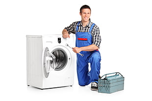 white front-load clothes dryer and a man holding combination wrench