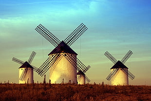 four brown-and-white windmills