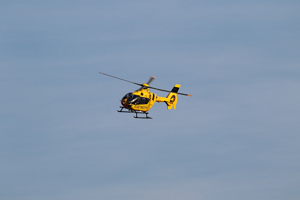 yellow and black helicopter top of sky HD wallpaper