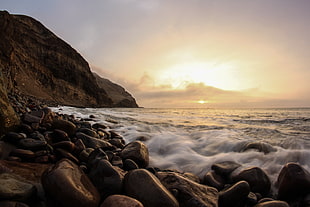 time lapse photography of sea waves against shore of black rocks during sunrise, la herradura HD wallpaper