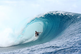 man riding surfboard on sea wave, teahupoo, tahiti