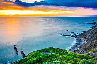 photograph of body of water during sunrise, bude, united kingdom