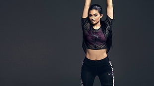 woman in black leggings showing exercise move