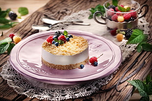 cake with fruit on top of pink ceramic plate