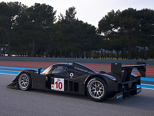 black racing car on tarmac