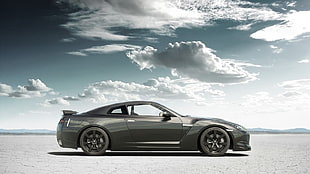 grey coupe on desert under grey clouds at daytime HD wallpaper