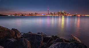 cityscape photography of a city under calm blue sky during nighttime