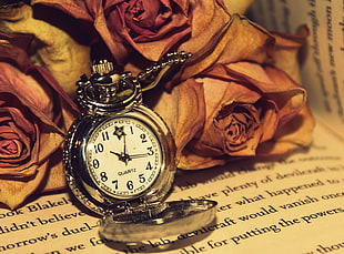 round silver-colored pocket watch at 10:15