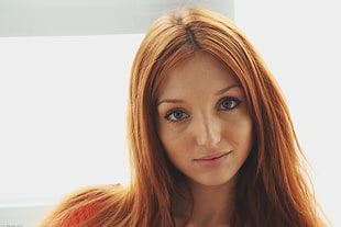 person showing red haired woman with whit background