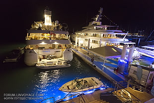 two white cruise ships during nighttime