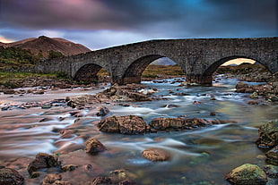 landscape photo of a river with gray stone bridge, sligachan