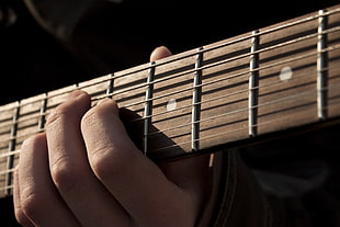 person holding guitar chords