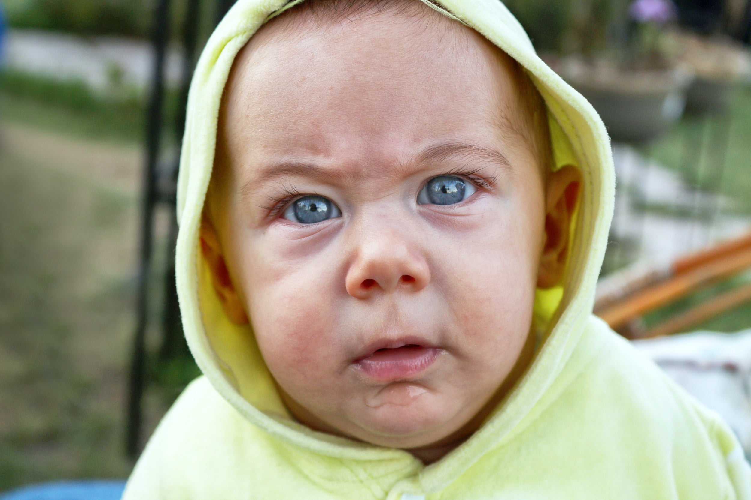baby's green hoodie jacket, baby, blue eyes, angry