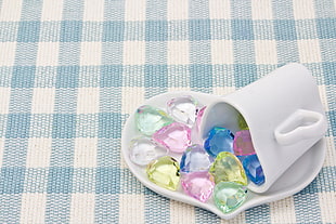 white ceramic mug on heart shaped ceramic saucer filled with assorted color stones HD wallpaper