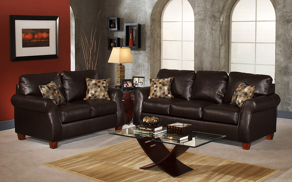 two black leather 3-seat and 2-seat sofas in floor near window HD wallpaper