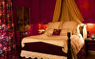 brown wooden canopy bed frame with mattress
