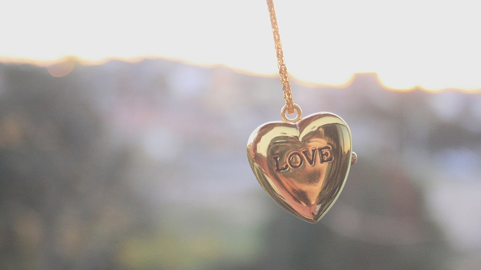 selective focus photography of gold-colored heart locket pendant HD wallpaper