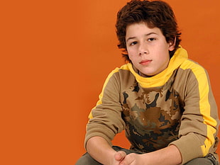 boy in brown and yellow sweater HD wallpaper