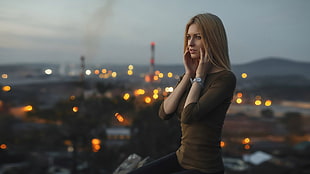 woman with long-sleeved shirt on top of building during night time HD wallpaper
