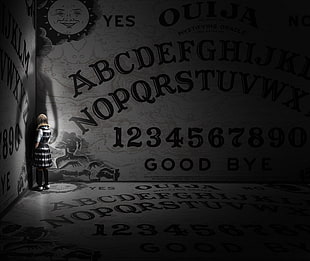 person wearing white and black dress inside ouija board printed room