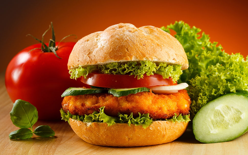 hamburger with tomato on brown wooden table HD wallpaper