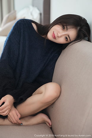 woman wearing black sweater on sofa