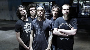 group of men wearing black crew-neck shirts