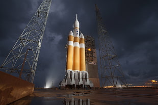 orange and white space shuttle, landscape, clouds, storm, NASA