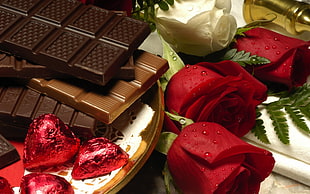 brown chocolates with red roses filled with water droplets