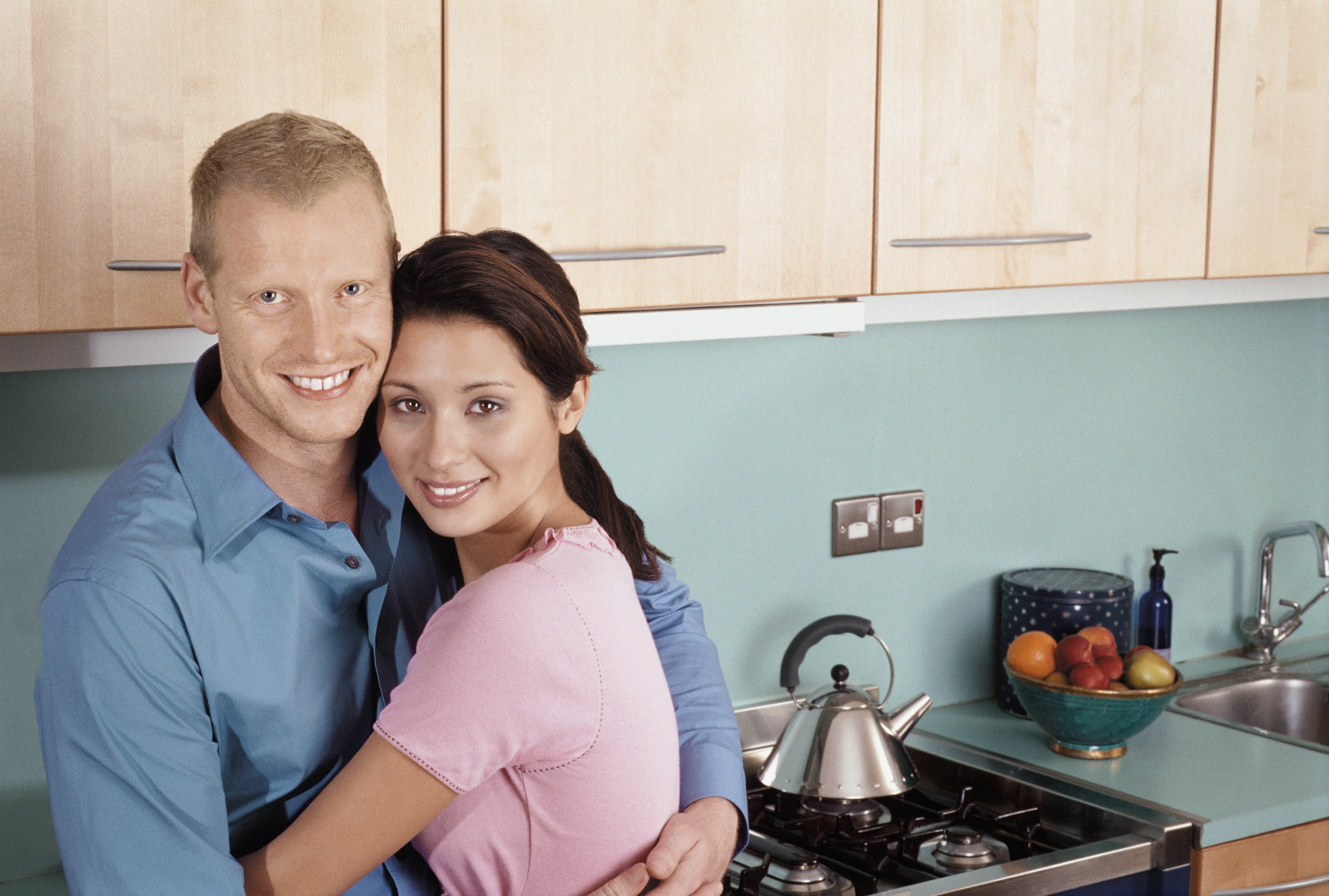 photo of man wearing blue dress shirt beside woman wearing pink top