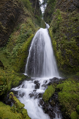 waterfalls in between rock formation