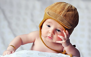 baby with brown critter cap