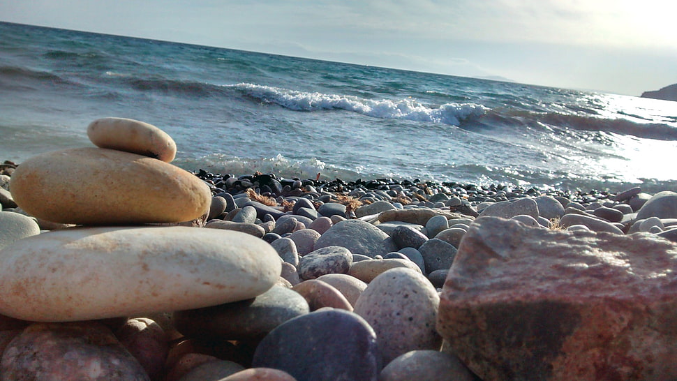 assorted-color-and-shape rock lot, coast HD wallpaper