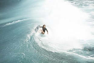 photo of woman surfing
