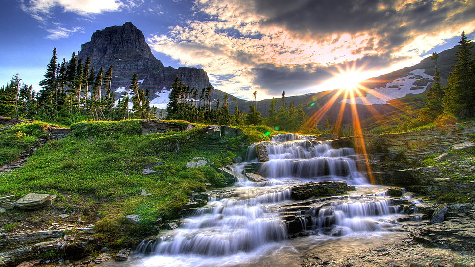 waterfalls between green grasses during sunrise HD wallpaper