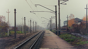 railroad under cloudy sky during daytime
