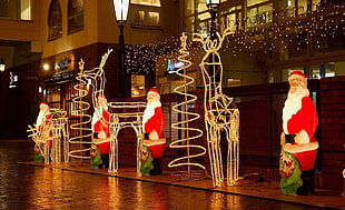 four Santa Claus statues