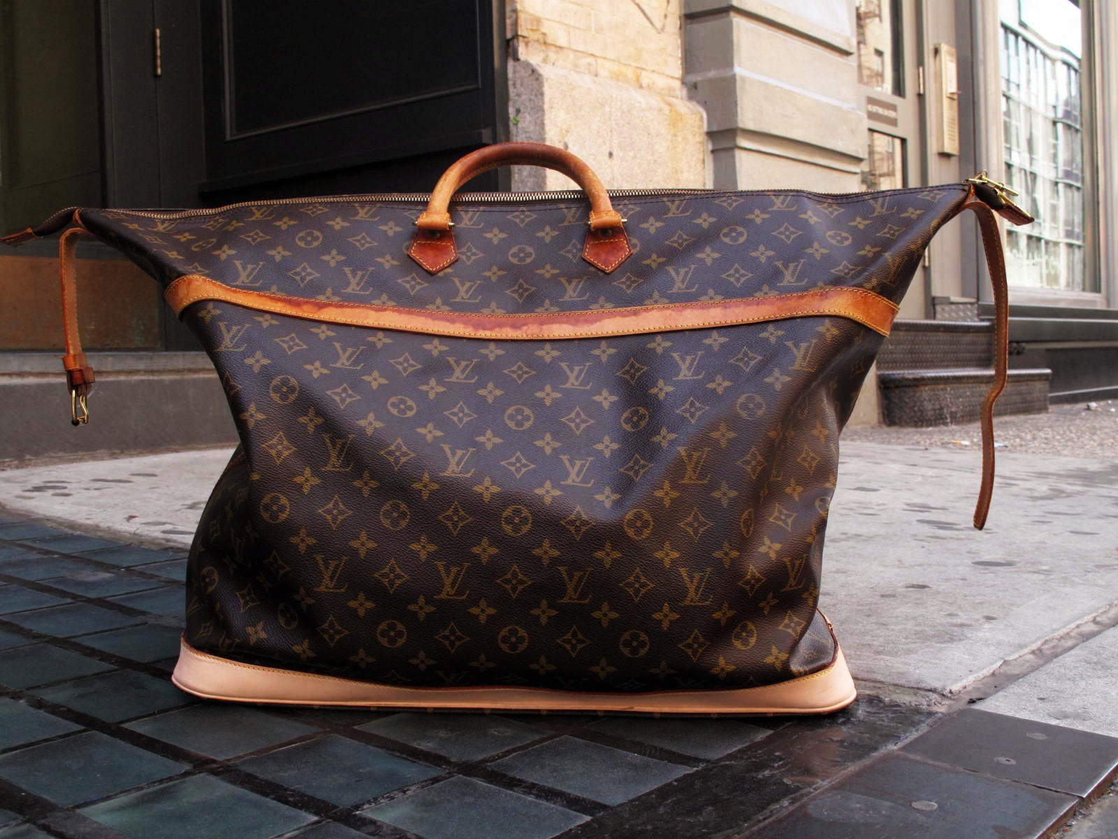 Women's brown leather Louis Vuitton hand bag on concrete surface HD  wallpaper | Wallpaper Flare