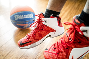 pair of red-and-white Nike basketball shoes near Spalding basketball HD wallpaper