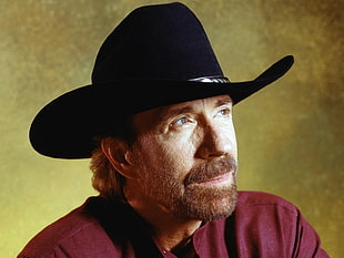man in red collared shirt and black leather cowboy hat