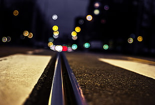 low angle photography of road with bokeh lights background