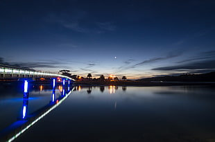 timelapse photography body of water beside bridge during sunrise HD wallpaper