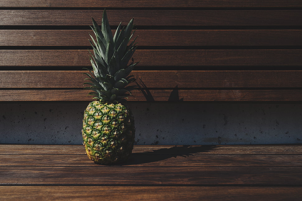 pineapple on brown wooden surface HD wallpaper