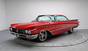classic red coupe parked near white painted wall HD wallpaper