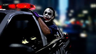 Joker riding police car