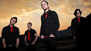 four men in black shirts and red neckties
