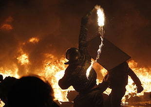 men's black suit, protestors, bombs, Ukraine, fire