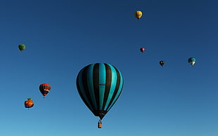 teal and black stripe hot air balloons during daytime