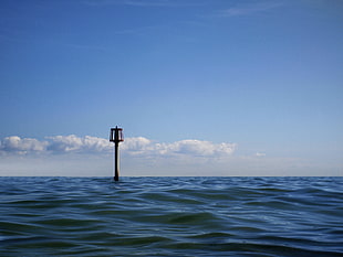 tower on the sea under blue sky during daytime HD wallpaper