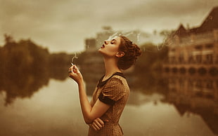 woman smoking in brown dress